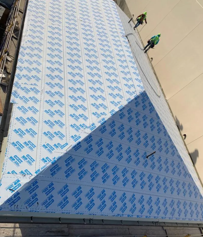 Professional roofers installing underlayment on a metal roof in Beltsville